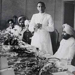 Maharaja Pratap Singh of Nabha seated at a table set with the Minton dinner service ordered by his father, c. 1942