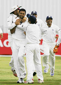 Indias VRV Singh celebrates with team-mates after dismissing Rest of South Africas Morne van Wyk on the third day of the warm-up match at Potchefstroom on Saturday