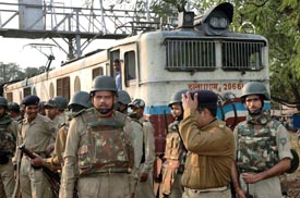 District police along with railway police personnel assess the situation after a passenger train was hijacked by Maoists from Chakula station near Singhbum district in Jharkhand on Sunday