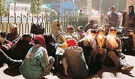 Migrant labourers wait outside the Ludhiana railway station in the cold on Sunday