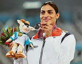 Indias Manjeet Kaur holds the silver medal won by her in the womens 400 m race at the Khalifa Stadium in Doha on Sunday. Kazakhstans Olga Tereshkova bagged the gold, while Japans Asami Tanno took the bronze