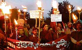 Members of the Haryana Roadways Workers Union hold a protest rally outside The Tribune building