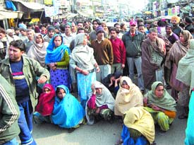 Residents of Dhira village block traffic in Pathankot on Tuesday