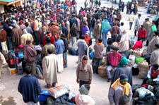 Stranded passengers try to get tickets at the State Road Transport Corporation (SRTC) office after opening of the Srinagar-Jammu road was announced in Srinagar on Tuesday.
