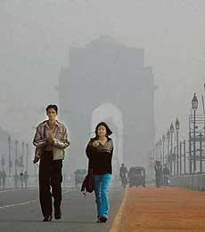 The early morning fog, which enveloped New Delhi on Tuesday, casts a hazy spell over India Gate.