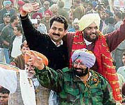 Chief Minister Amarinder Singh, MP Rana Gurjit Singh and Jalandhar Improvement Trust Chairman Tejinder Singh Bittu greet supporters on the second day of Congress Punjab Vikas Yatra in Jalandhar on Tuesday