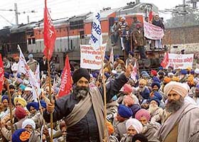 Activists of various farmers organisations block rail traffic at Amritsar Railway station