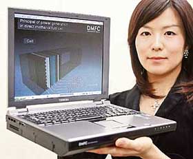 A Toshiba employee displays a prototype model of notebook computer, powered by direct methanol fuel cell (DMFC) battery in Tokyo on Thursday. 