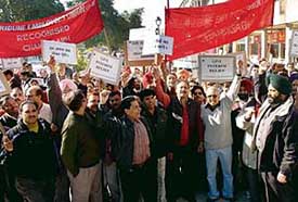 Members of the Confederation of Newspapers and News Agencies Employees Federation, Chandigarh, hold a protest rally held at the Sector 17 plaza on Thursday