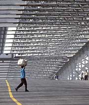 A porter carries a load through the deserted Howrah bridge in Kolkata on Thursday. Life was paralysed in the Left Front-ruled West Bengal following a 24-hour nation-wide general strike called by Left-affiliated trade unions against the UPA government's economic and industrial policies.