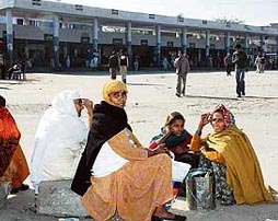 Women commuters stand clueless as the protesting employees unions block entry of buses into the bus stand at Bathinda on Thursday.
