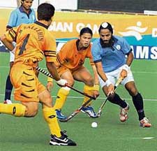 Rajpal Singh in action during the classification match for the 5th-6th place between India and Malaysia in Doha on Thursday