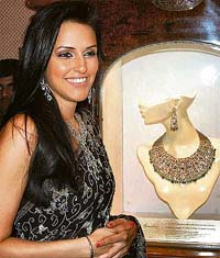 Actress Neha Dhupia wears a 'Bella' jewellery collection, designed by Shobha Asar, at its launch in Bangalore