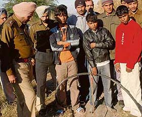 The three boys involved in stealing signal cable of the Railways at the spot where it was recovered, near Bapu Dham colony