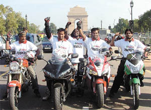 A team of motorcyclists exults at the end of the 'Great Indian Road Trip'