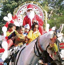 Students of First Step Play School take a ride with Santa Claus to celebrate Christmas in Ludhiana.