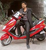 Mr Ajinkya Firodia, Vice-President (Marketing), Kinetic Motor Company Ltd, poses with the newly launched Kinetic Italiano Blaze scooter, priced at Rs 54,000, in New Delhi on Monday. Blaze is one of the seven models Kinetic acquired from Italian two-wheeler maker Italijet. The company would launch two 135cc and 250cc scooters from the Italijet range in the next fiscal. 