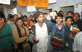 Workers from a sports goods manufacturing company hold a protest outside the Laboure Commissioners office in Jalandhar on Monday. 