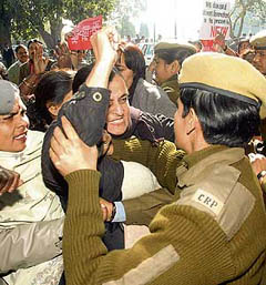 Activists of the National Federation of Indian Women shout slogans as they attempt to enter Parliament House during a demonstration on the issue of the Women's Reservations Bill in New Delhi on Monday.