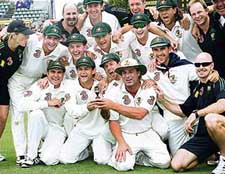 Members of the Australian team hold a replica of the Ashes urn