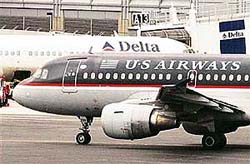 A US Airways jet moves past a Delta Airlines plane at Logan Airport in Boston. Delta Airlines said its Board had rejected a $8.4-billion acquisition bid from rival US Airways Group Inc., calling the bid "structurally flawed" and plagued by anti-trust and labour issues.
