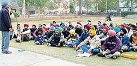 Members of the Democratic Employees Front hold a rally in Ludhiana on Tuesday