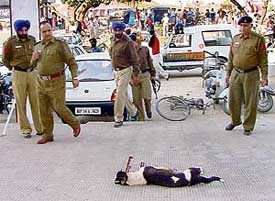 Cops examine the spot where a bitch was killed in an explosion near the Solitaire hotel, NAC, Mani Majra, on Wednesday
