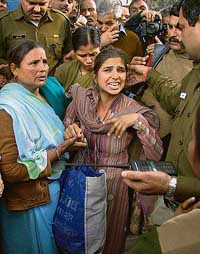 Lakshmi Kumari, sister of a jawan killed in Operation Parakaram, after she was foiled in her self-immolation bid in front of the PIB conference hall in New Delhi on Wednesday. 