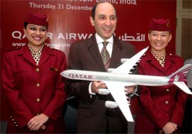 Mr Akbar AL Baker (centre), CEO, Qatar Airways, flanked by stewardesses, poses with an aeroplane model in New Delhi on Thursday.