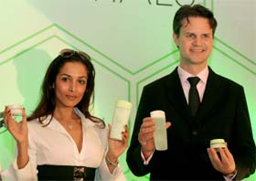 Bollywood actress and Oriflame brand ambassador Malaika Arora Khan poses with Mr Tomas Eriksson, Managing Director, Oriflame India, as they display 'Oriflame' advanced natural Swedish cosmetic skin care products at their launch in New Delhi on Thursday.