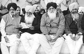 Mr Parkash Singh Badal and other SAD leaders in a pensive mood at a rally in Gurdaspur on Thursday.