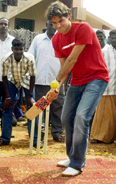 Swiss tennis star Roger Federer plays cricket during a visit to Chinnur Pudupettai village of Cuddalore on Saturday.