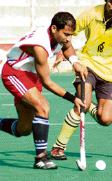 A Corps of Signals player in action against Punjab & Sind Bank during a league match of the Ramesh Chander Memorial Hockey Tournament in Jalandhar on Saturday. PSB won 4-2.