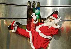 A man dressed as Santa Claus is entertaining children at the Sukhna Lake in Chandigarh on Sunday