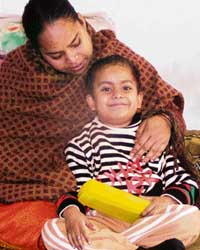A smiling Shivam, suffering from blood cancer, along with his mother in Mohali