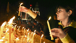 A girl lights candles on the eve of Christmas at the Sacred Heart Cathedral in New Delhi on Sunday.