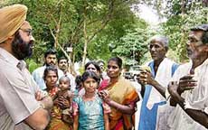 District Collector Gagandeep Singh Bedi listens to the woes of the labourers who were rescued recently from Koranial village in Ernakulam district.