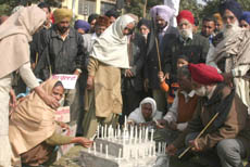 Relatives of those who perished in the Malta boat tragedy 10 years ago light candles in their memory at Company Bagh, Jalandhar, on Monday.