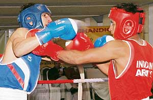 Pugilist Chote Lal (left) from the Army Sports Institute, Pune, tries to knock down Delhis Deepak during a bout at the AK Mishra Boxing Championship at the Sector 10 skating rink in Chandigarh on Wednesday. 