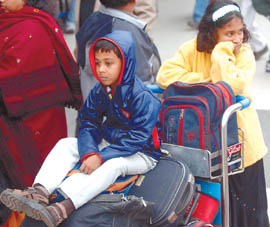 Passengers waiting for their flights at IGI Domestic airport in the Capital on Wednesday. Many flights were cancelled or diverted due to fog.