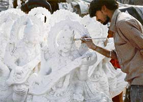 A sculptor from Rajasthan gives finishing touches to idols of Saraswati in Ludhiana