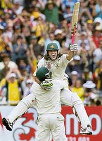 Australian batsman Andrew Symonds leaps into the arms of team-mate Matthew Hayden after scoring his maiden century on the second day of the fourth Ashes Test in Melbourne on Wednesday. 