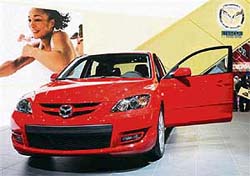 In this file photo, a Mazda 3MPS with a 260 hp turbo engine is on display as the first world presentation at the 76th Geneva Motor Show in Geneva, Switzerland. Japan's Mazda Motor Corp. said on Thursday it would restart the sale of its locally built Mazda 3 compact car in China next month after a suspension of over nine months.