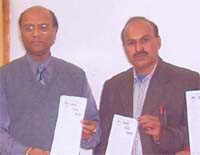Mr Ramesh Mittal, Chairman of Lovely Professional University (left), releases literature prepared by the Vigilant Peoples Front for distribution among voters, in Jalandhar on Thursday