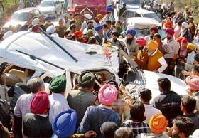 People pull out the body of Santokh Singh from a Scorpio that was involved in an accident of three vehicles on the Chandigarh-Rajpura highway at Jang Pura village, near Banur