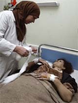 A nurse attends to a bombing victim in a hospital in Baghdad on Thursday. A car bomb exploded at a petrol station in central Baghdad killing 10 people. 
