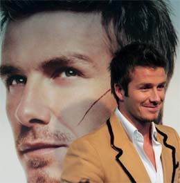 Real Madrid soccer star David Beckham at a promotional event for Motorola in Tokyo on Friday. Beckham signed on the back of a Motorola mobile phone, which would be auctioned and sold online and the profits donated to UNICEF.  AP