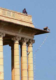 Labourers decorate Central Sacretariat Buildings with lights ahead of the comung Republic Day celebrations