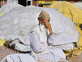 Gurcharan Singh, a farmer from Kot Shamir village, awaits procurement of his cotton in Bathinda on Friday.