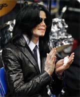 Pop star Michael Jackson applauds a speaker during a public viewing and funeral of legendary singer James Brown in Augusta, Georgia, on Saturday.  Reuters